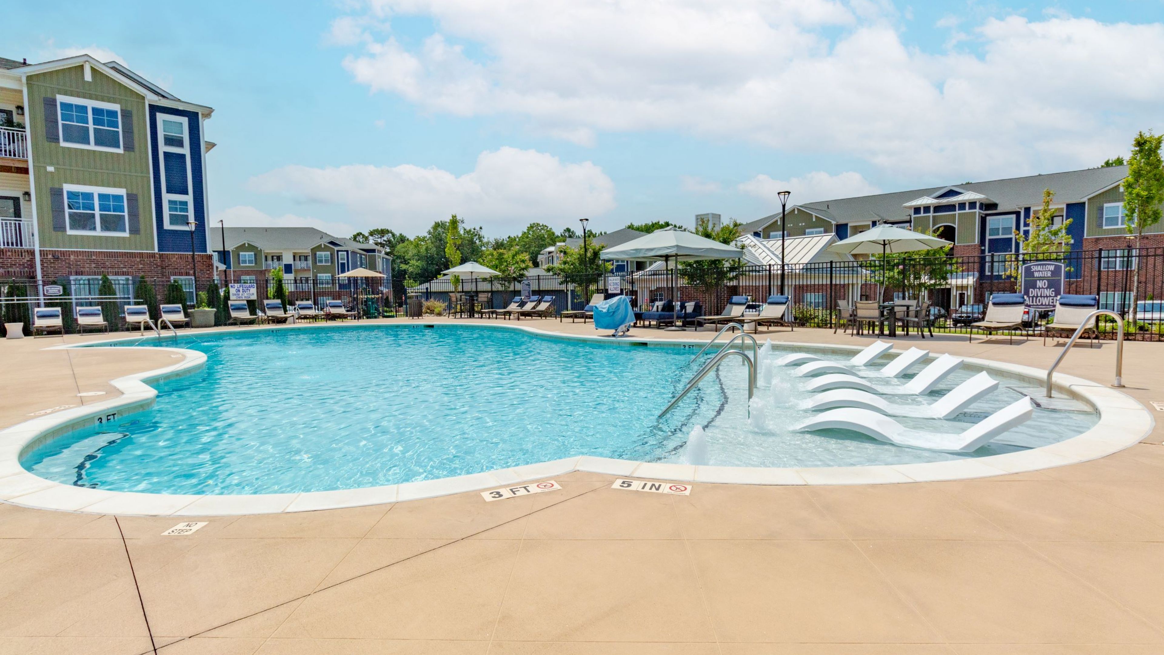 Hawthorne at Simpsonville luxury outdoor pool with in-pool lounge chairs and surrounding seating