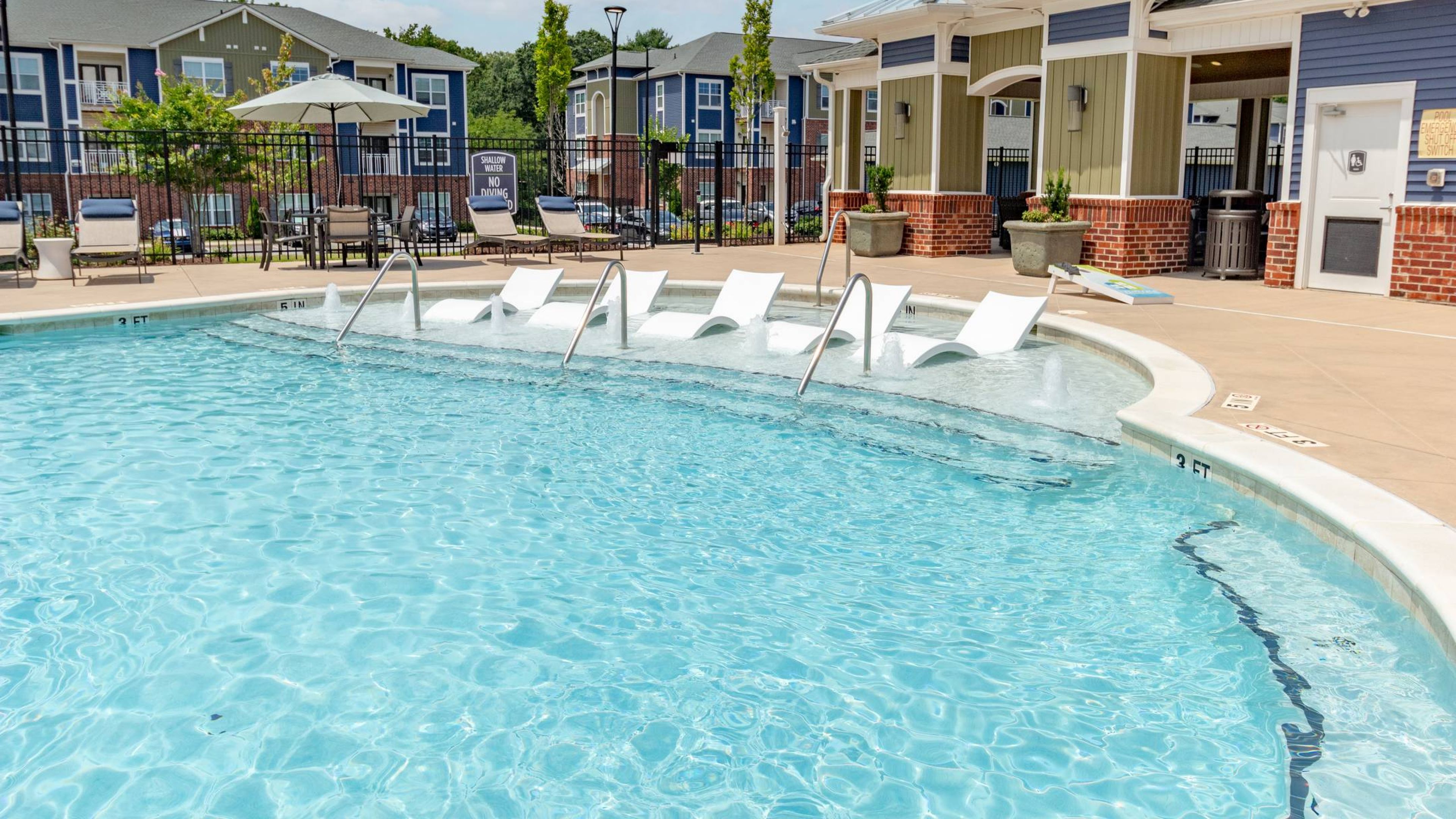 Hawthorne at Simpsonville apartments community exterior with large green lawn and jungle gym