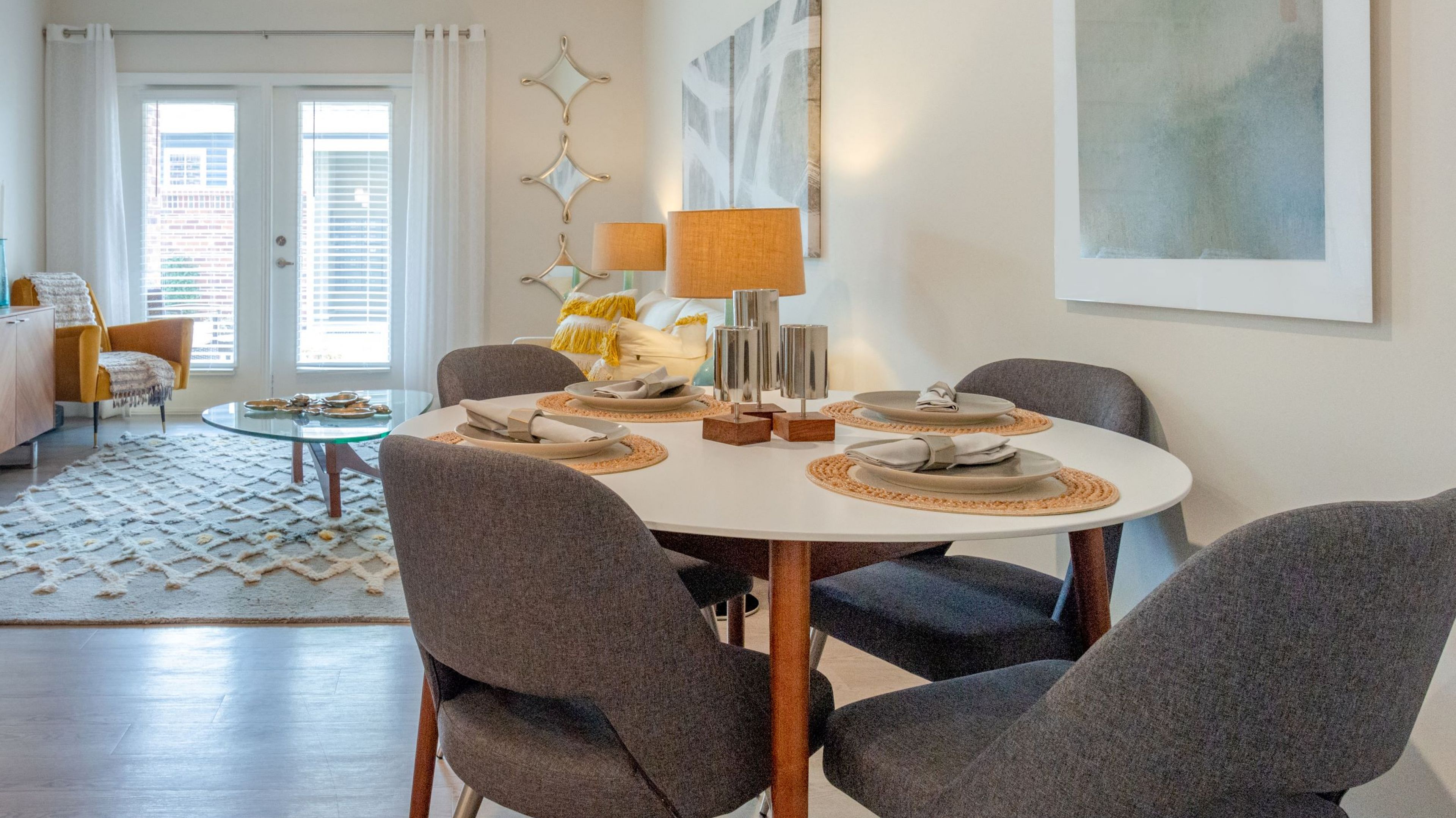 Hawthorne at Simpsonville apartment living room with large patio doors, furnished with a dining table and chairs